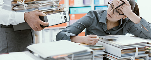 Stressed Woman receiving various files